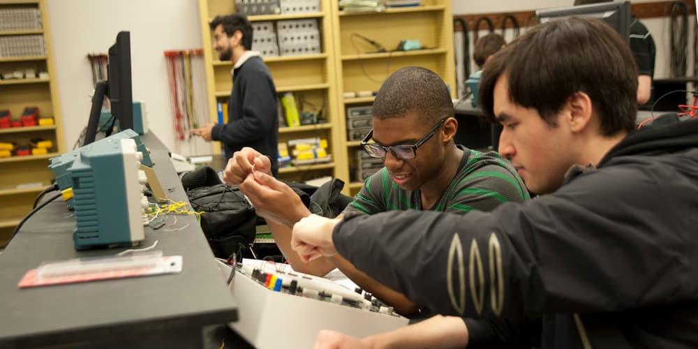 two students working on a project in an engineering lab