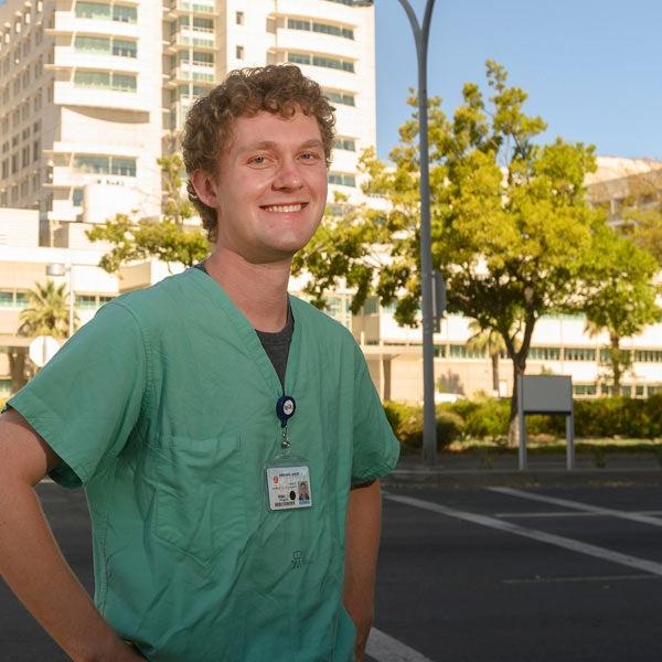 A medical student poses outside of the UC Davis medical center