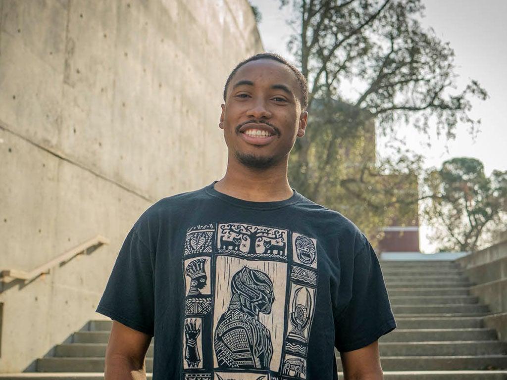 A portrait of Nate Walker standing on one of the many staircases at the Social Sciences Building on the UC Davis campus