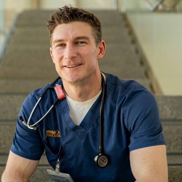 A male nursing student poses for a quick photo in the Betty Irene Nursing school at UC Davis