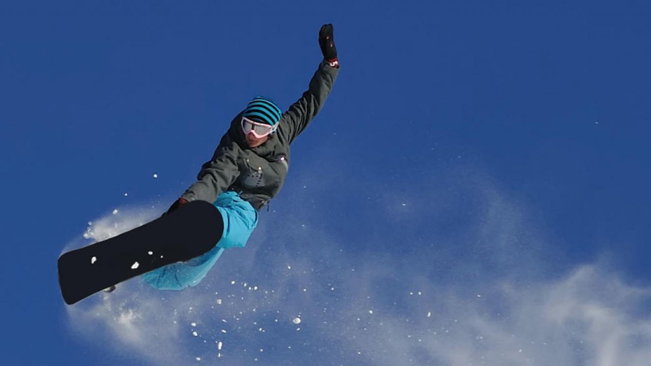 A snowboarder sends it off a sierra slope