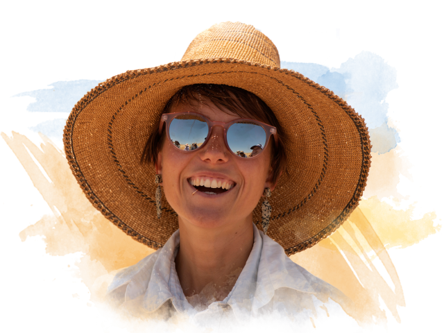 Young woman smiling with a sun hat on