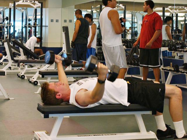 A male student works out in the UC Davis Activities and Recreation center weight room