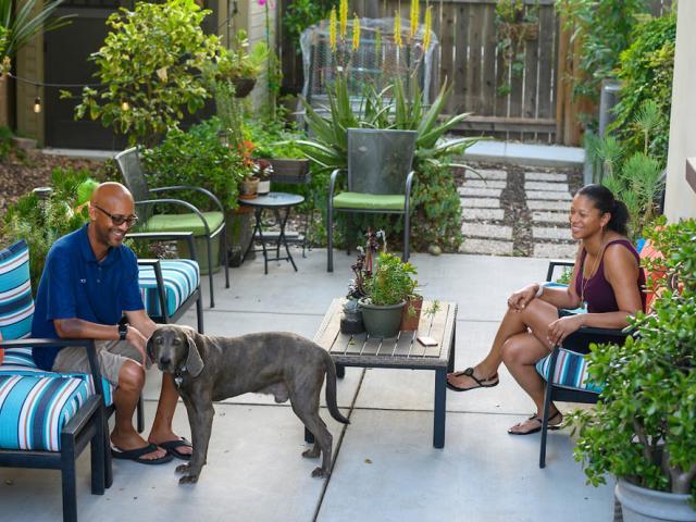 Scott Stevenson and his wife play with their dog on their back porch