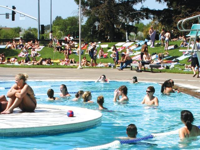 Students sunning themselves at the UC Davis rec pool