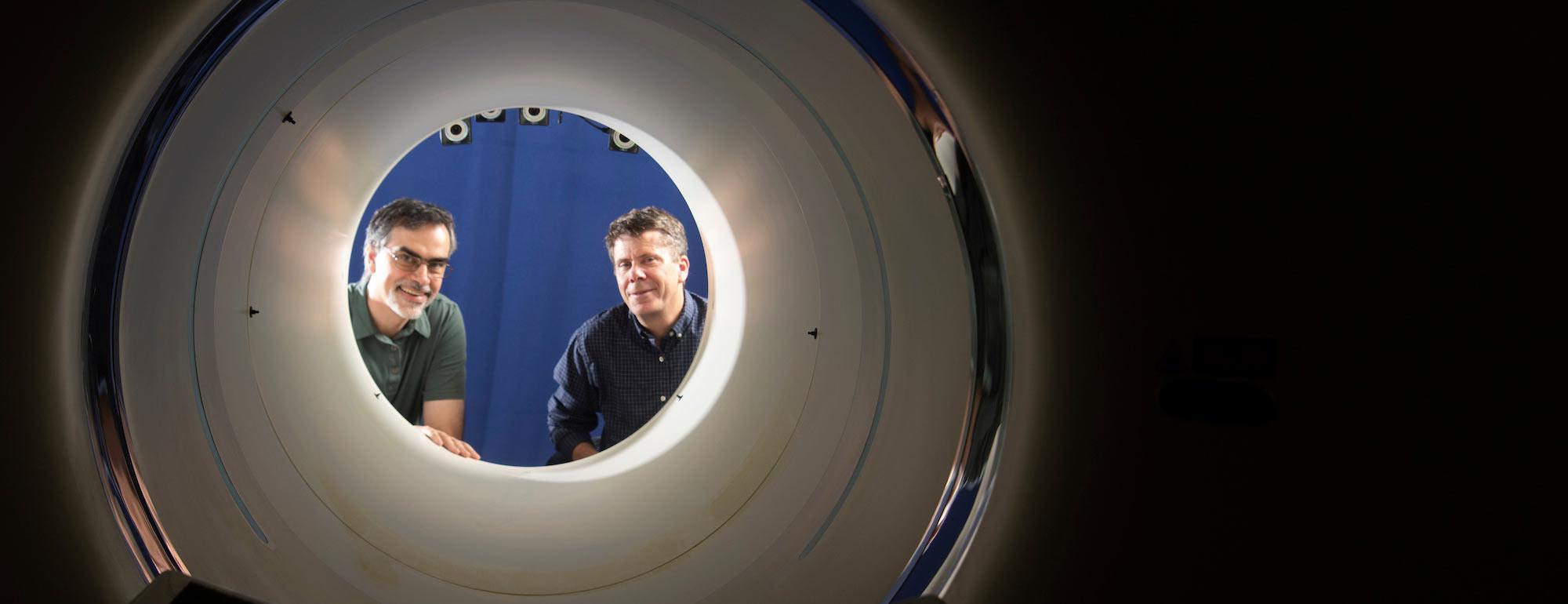 Two men pose at the opening of a new full body PET scanner that allows for easier medical diagnostics