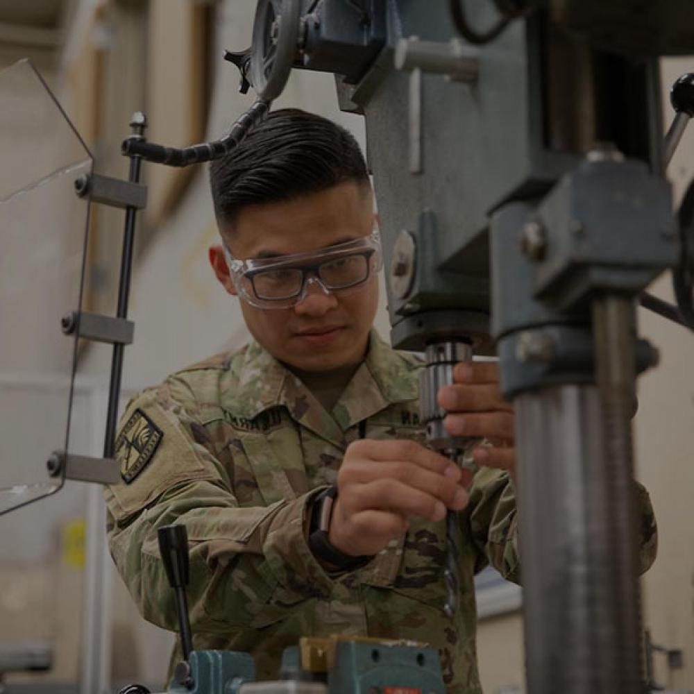 A ROTC student works a machine press