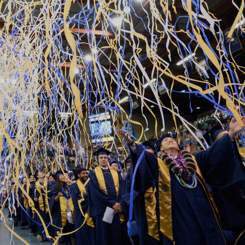 Streamers fall from the ceiling at the UC Davis Commencement ceremony