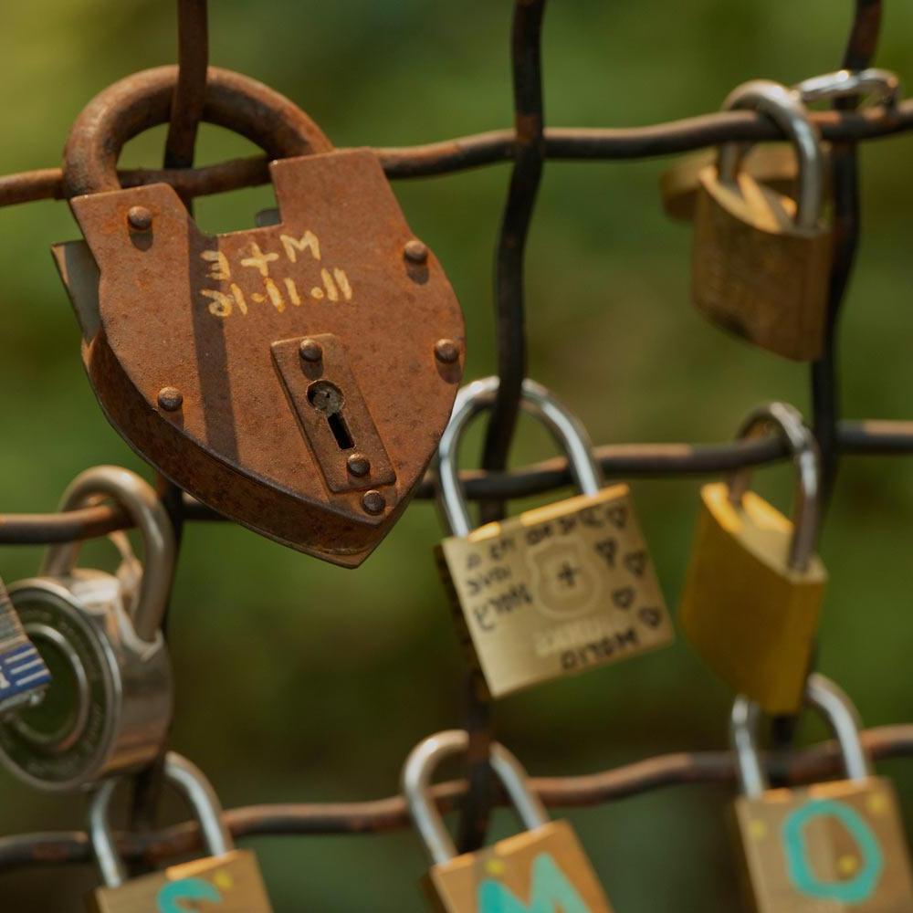 A heart shape lock locked on lover's bridge