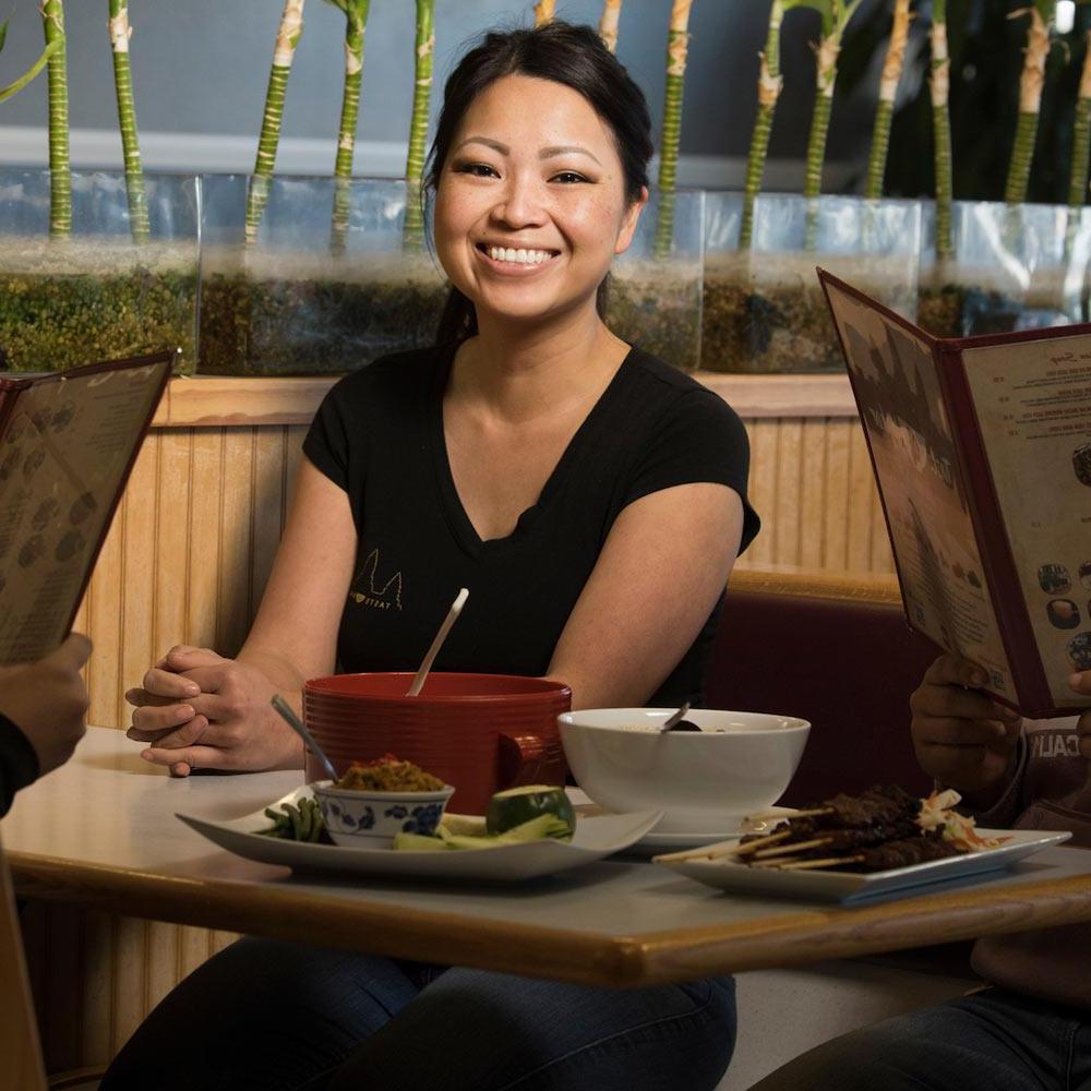 A woman sits in a booth at a local restaurant in Davis, ca
