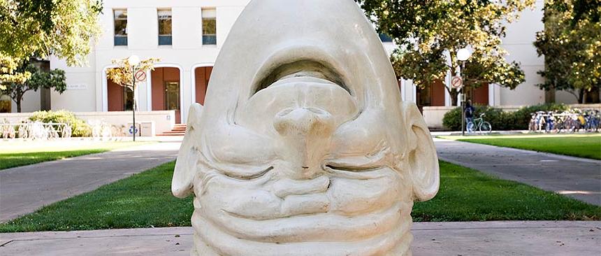 A sculpture of the "Fatal Laff" Egghead in front of Mrak Hall